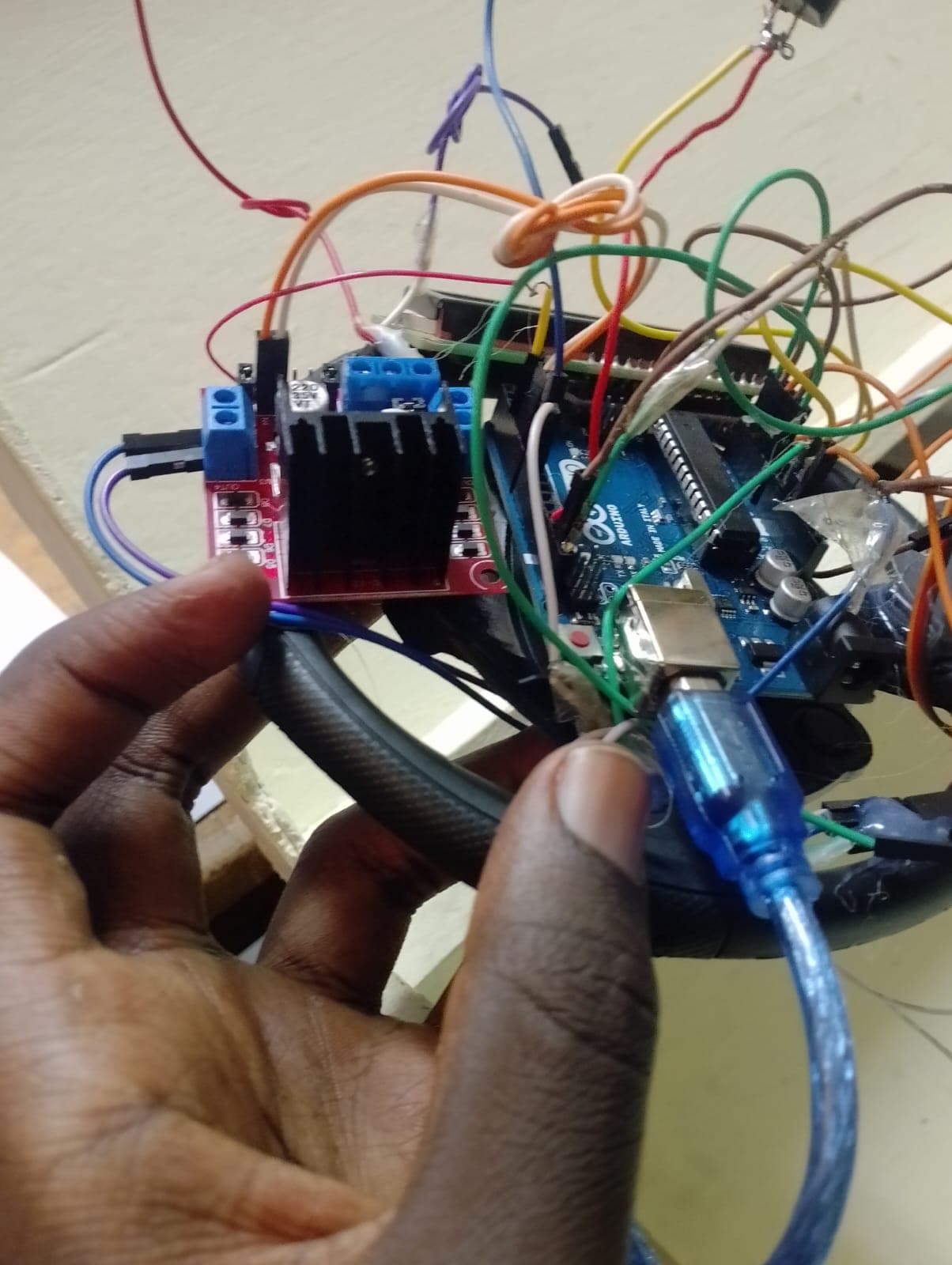 Handheld inspection of motor driver board and microcontroller wiring